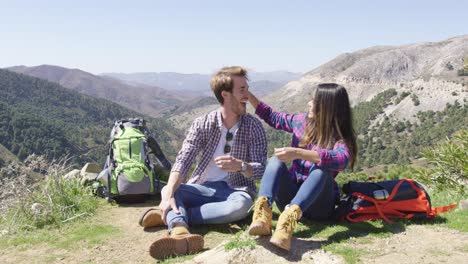 two people taking rest while hiking