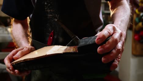 shoemaker repairing a shoe in workshop 4k