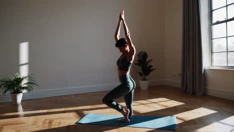 woman practicing yoga in a sunny room