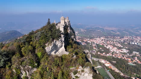 drone shot of the historic guaita tower with panoramic views of san marino’s landscape.