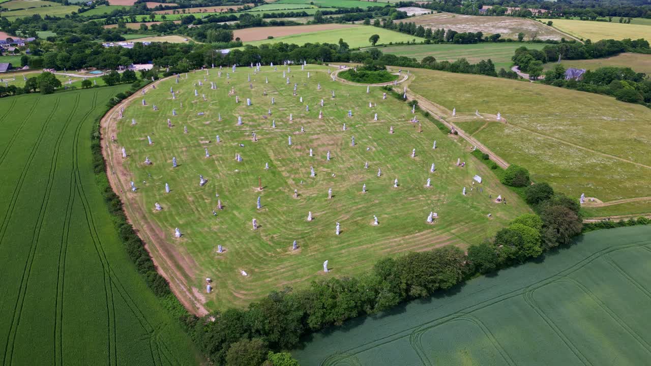 La Vallée des Saints, Valley of the Saints, Brittany, monumental granite sculptures of Breton saints in beautiful rural landscape, France. Aerial drone circling
