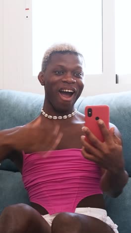 young man reacting with surprise and excitement while looking at his smartphone