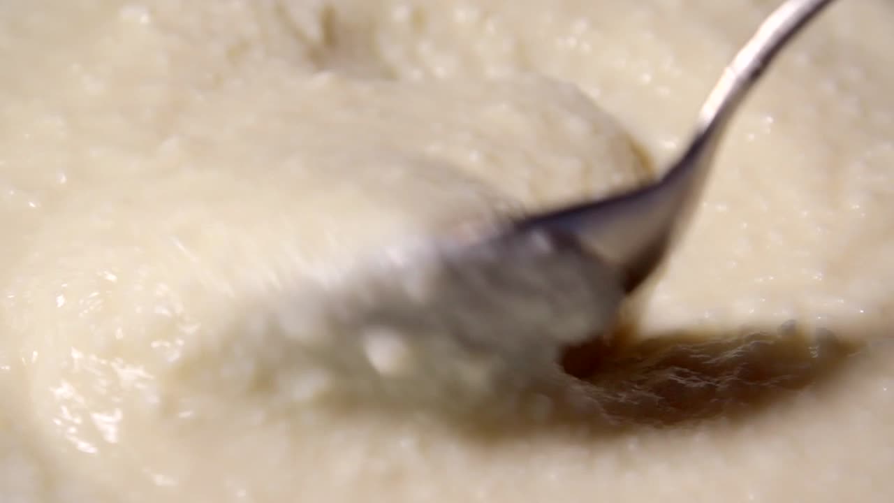 Taking melt creamy cheese with a spoon