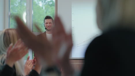 business conference or meeting in big company people are applauding first speaker