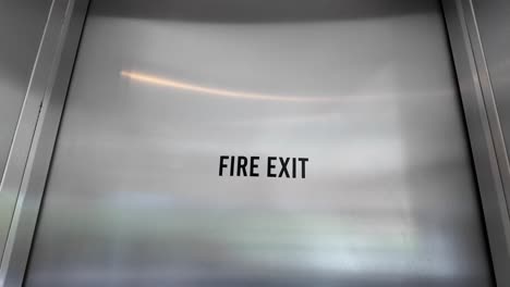 fire exit sign on metal door