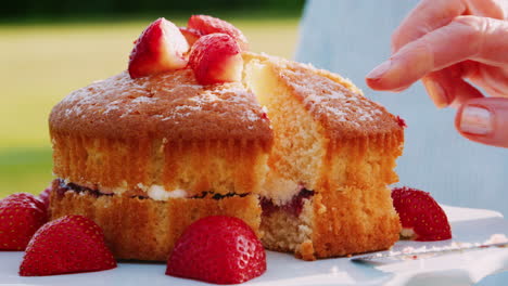 Close-Up-Of-Woman-Cutting-Slice-Of-Strawberry-Sponge-Cake