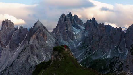 man running to cliff in dolomites, italy