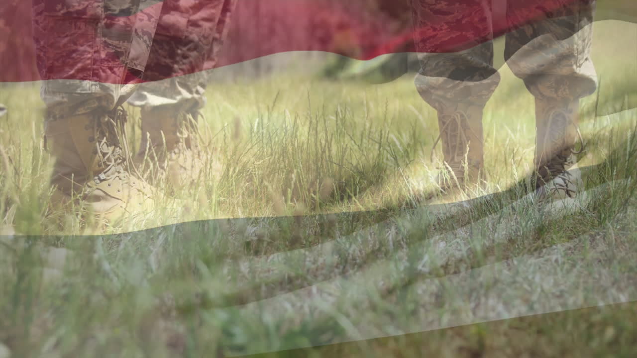 Military personnel walking through grassy field with flag overlay animation