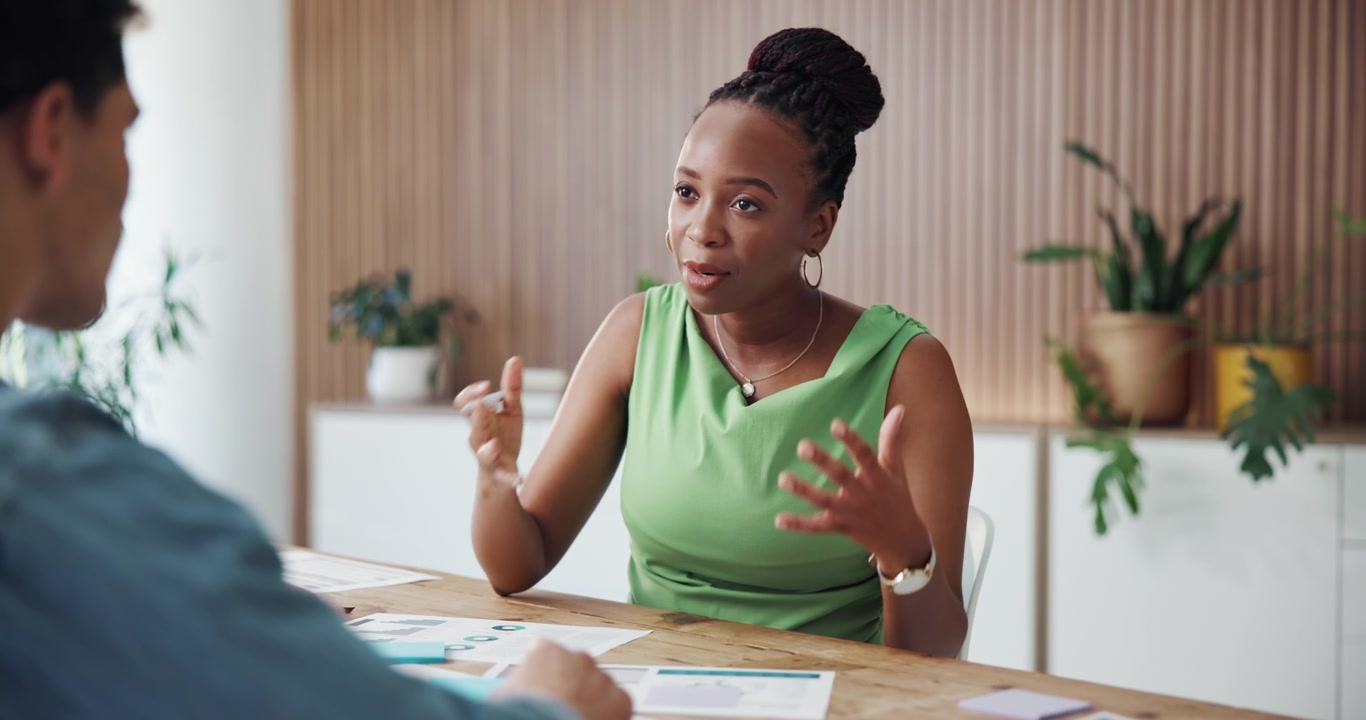 Professional Woman Discussing Business Strategy with Colleague in Office
