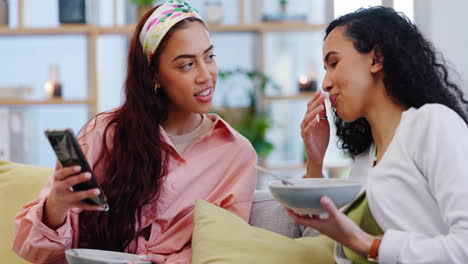 lesbian couple on sofa together with phone
