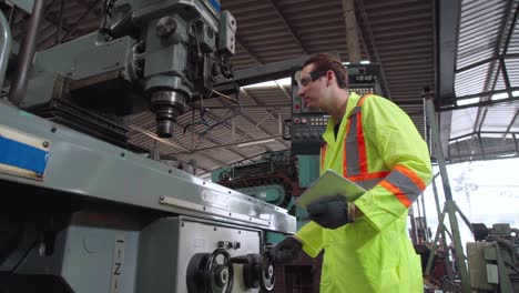 Smart-factory-worker-using-machine-in-factory-workshop