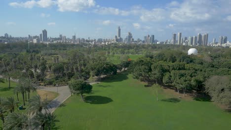 top view at the park facing in tel aviv, drone descending