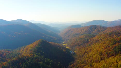 drone slowly descending above the fall colors in the north georgia mountains