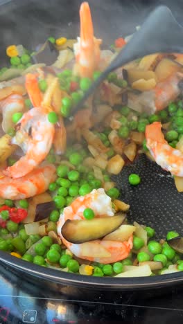 cooking shrimp and vegetables in a skillet