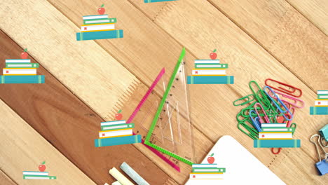 animación de iconos de libros sobre artículos escolares en fondo de madera