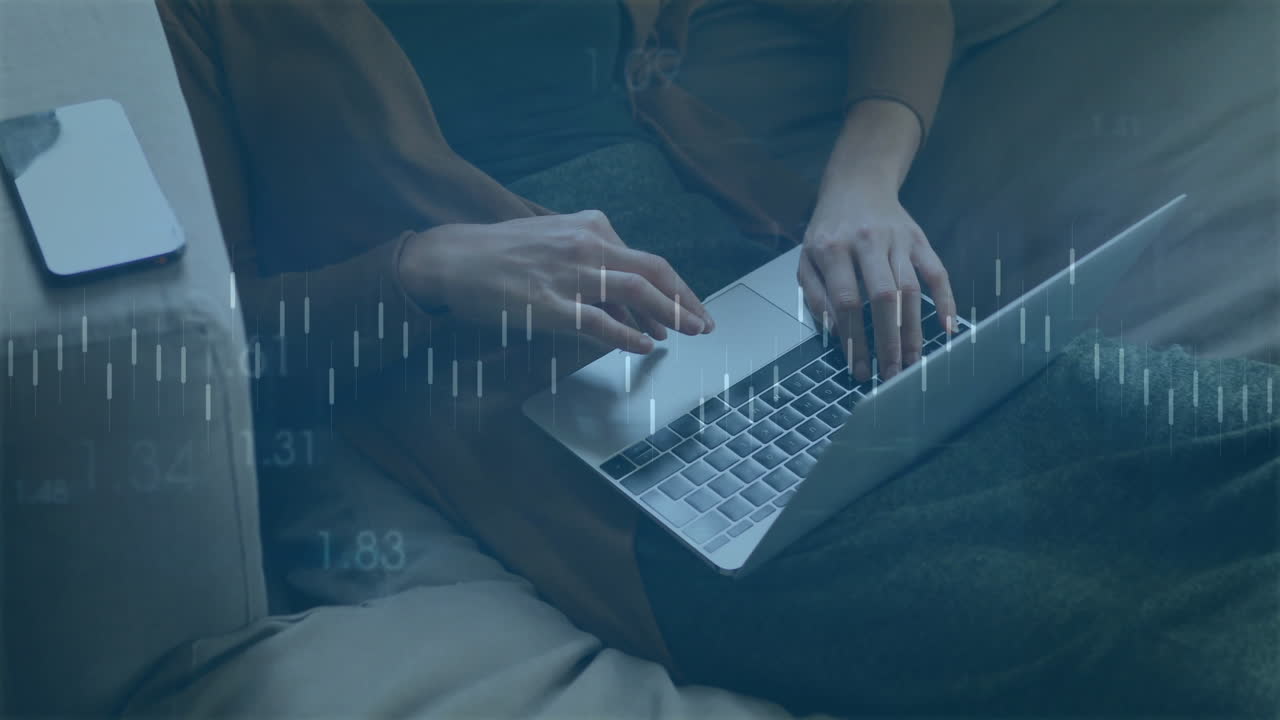 Woman typing on couch with laptop, showing floating candlestick charts and smartphone for finance