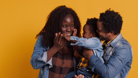 african american happy family fooling around together on camera