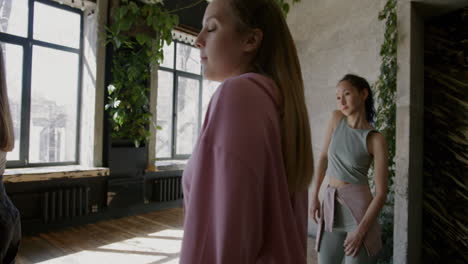 group of young women dancing or practicing fitness in a studio