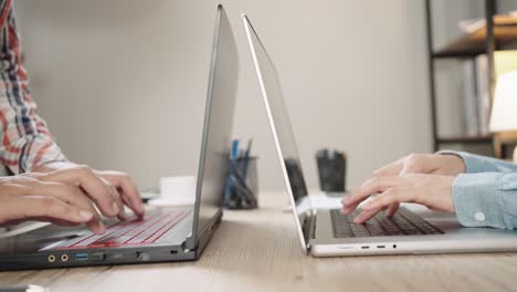 close up shot of businesswoman hands typing on laptop computer keyboard for searching information,online communication support,marketing research,business report in the office desk at night.