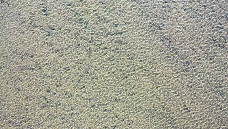 Drone-Aerial-of-Shallow-Ocean-Beach-and-Sand-with-Waves-Blowing-in-the-Wind