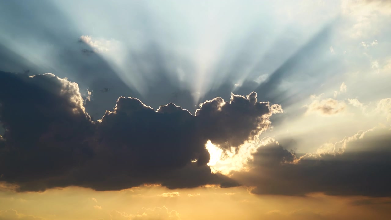 Sunlight Rays Breaking Through Dark Clouds at Sunset
