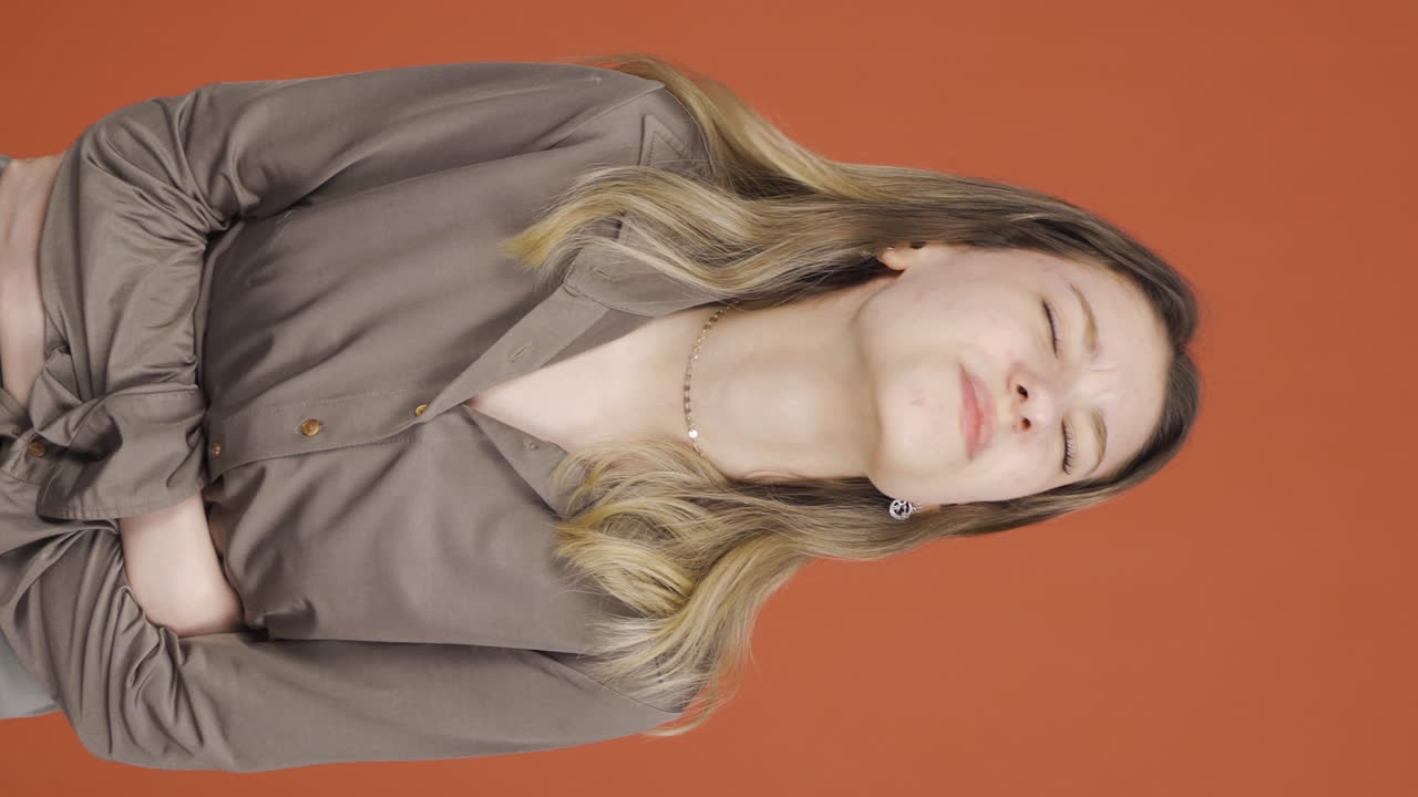 위통을 겪고 있는 젊은 여성의 수직 비디오.