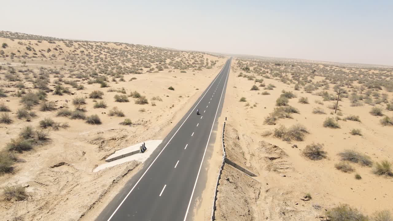 Aerial drone shot highlighting the freedom of a biker exploring the open desert landscape.