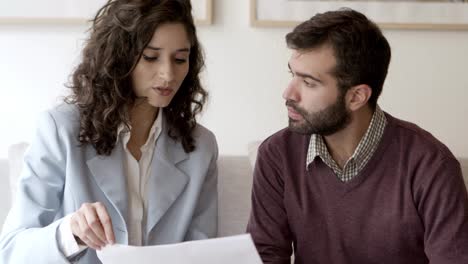 front view of focused home owner talking with interior designer