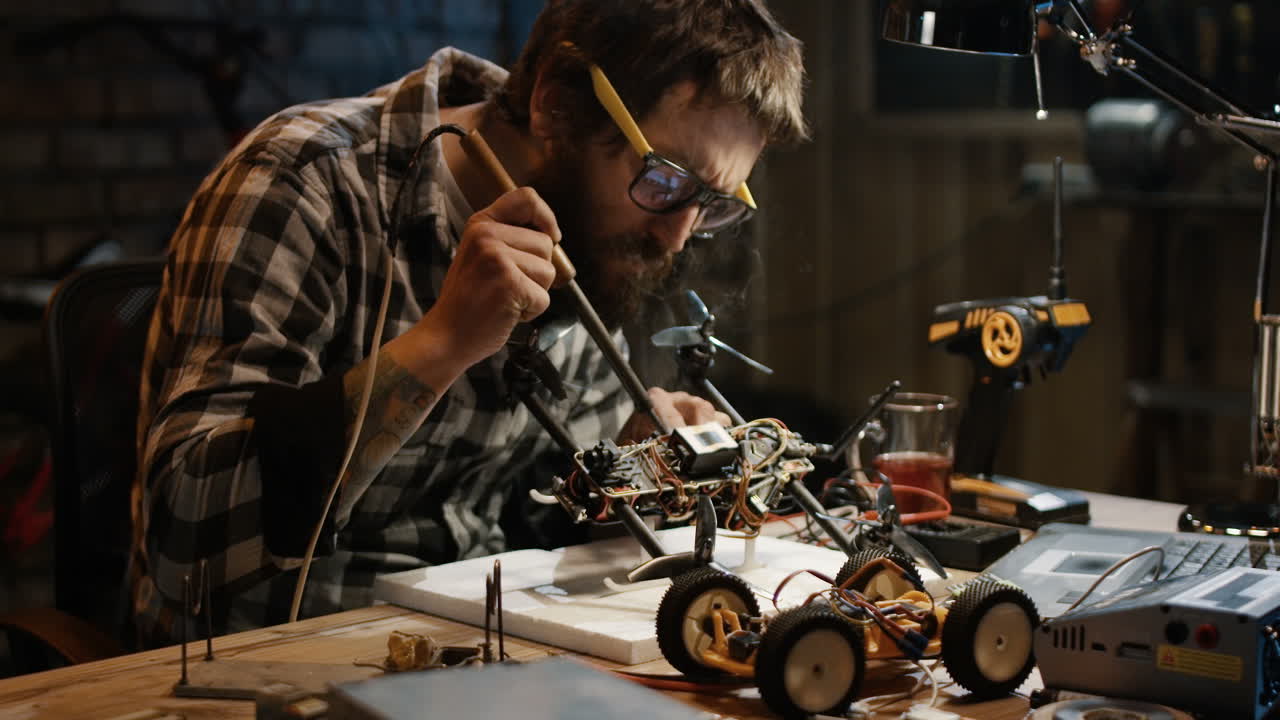 Hobbyist repairing a small RC car