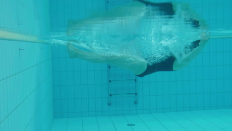 young sexy attractive woman let herself fall off in to the swimming pool water, releasing fear and letting go anxiety and dive underwater set her free, slow motion