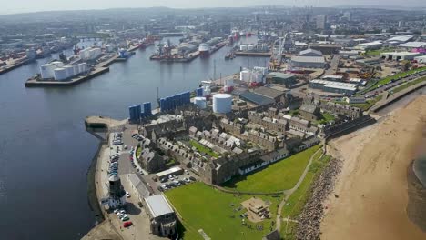 drone moving backwards over old fishing town and harbour