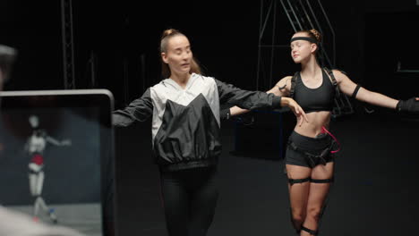 dancing woman wearing motion capture suit rehearsing ballet dance with instructor girl wearing mo-cap suit for 3d character animation for virtual reality technology