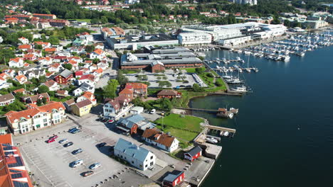 establishing drone shot of stenungsund harbor with boats and blue water in the day in bohuslan, sweden