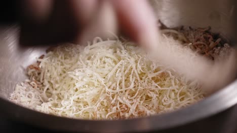 Mixing-Grated-Cheese-And-Ground-Oatmeal-Seasoned-With-Salt,-Black-Pepper,-And-Paprika