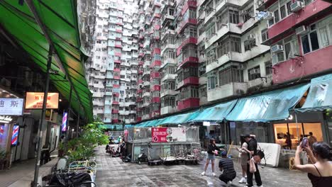 tourists take pictures of landmark monster building in hong kong, street view