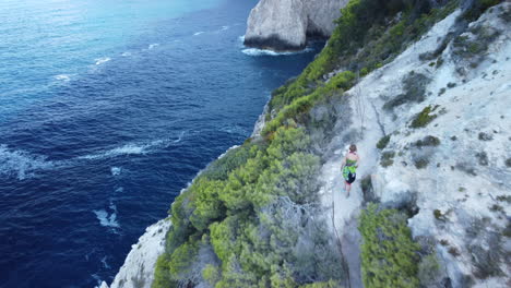 blonde girl walking on plakaki coastline