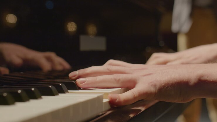 Musician Playing Grand Piano Accompanied by Violin