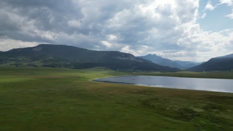 valley lake with ominous mountains and striking clouds