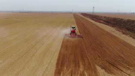 Agriculture-Tractor-Sowing-Hemp-Seeds-And-Cultivating-Field---aerial-shot