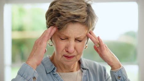 headache, senior woman and stress closeup at home