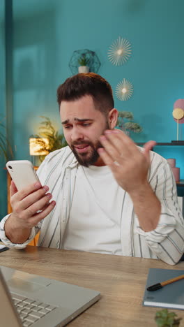 business man using smartphone bad news lottery game results fortune loss fail at home office