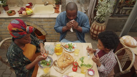 african american family having dinner at farm