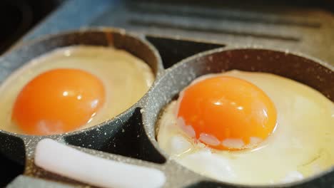 close up cooking scrambled eggs fried eggs on the stove in a frying pan for breakfast food, the concept of protein healthy food and diet