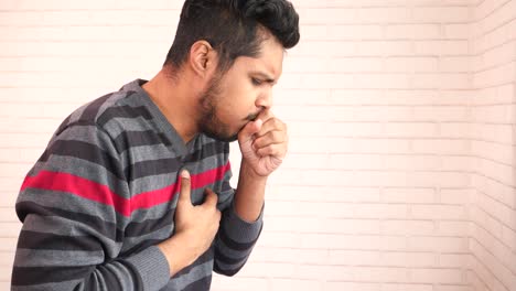 man coughing and ill