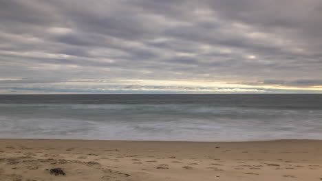 timelapse, clouded sky over ocean waves.