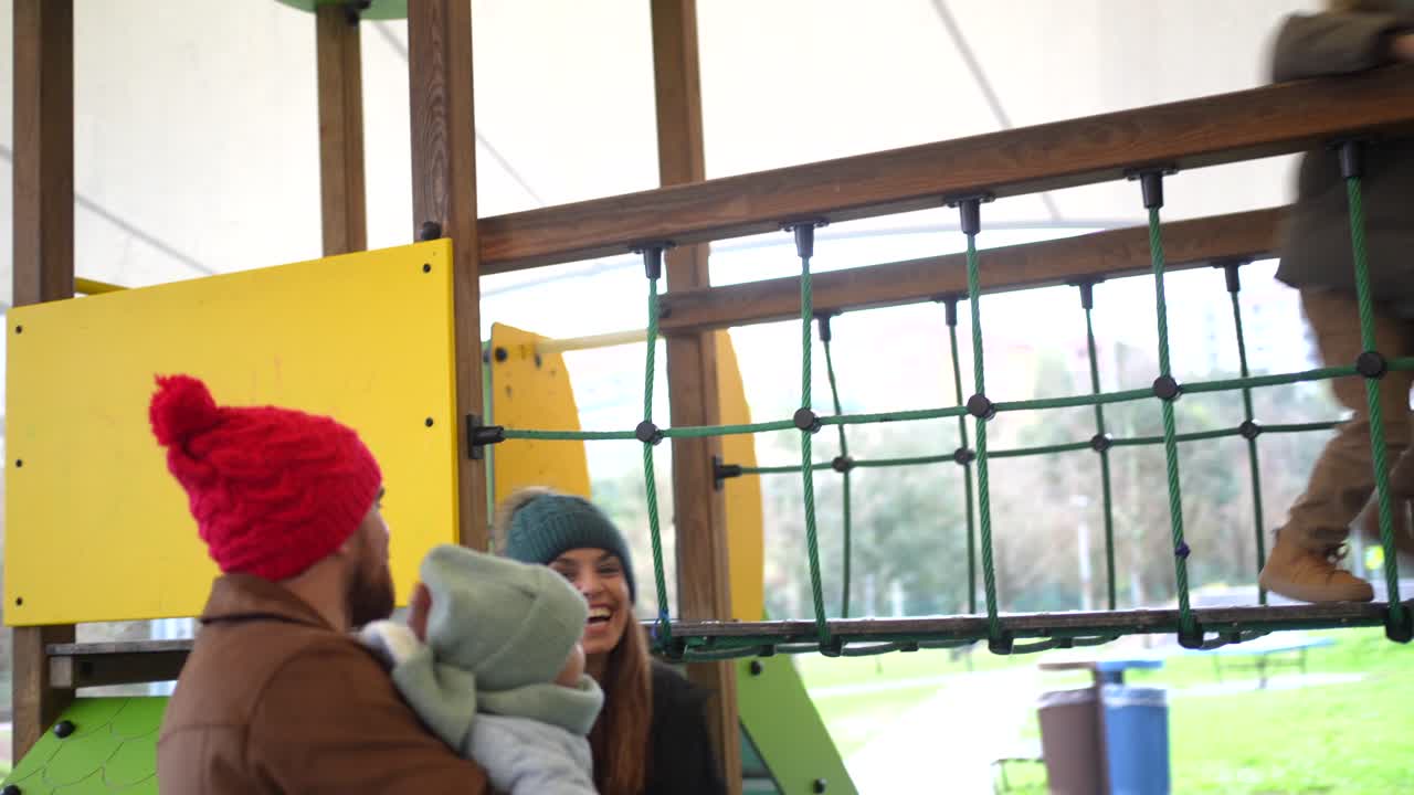 Happy Family Playing at the Playground