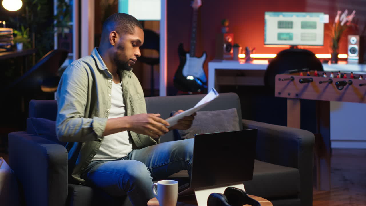 Vertical Video African american guy does research by reading articles and data driven papers
