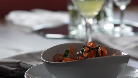 caucasian man eating orange pasta meal in a restaurant. - closeup shot