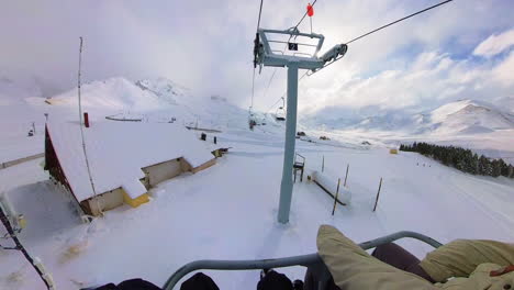 tourist enjoying ski lift ride with panoramic snowy mountains in resort, mendoza, argentina, hyperlapse
