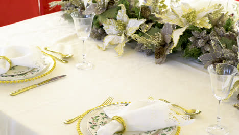 Beautiful-dining-table-decorated-for-Christmas-with-details-of-white-poinsettias-and-pine-cones